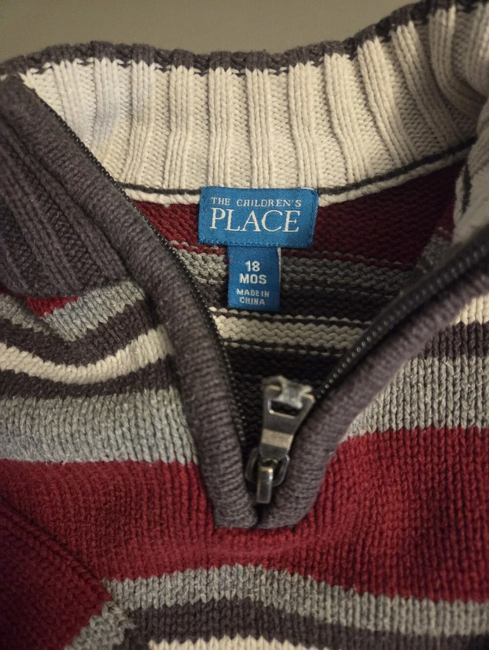 The Childrens Place Boys Striped Quarter-Zip Sweater in Burgundy and Gray.